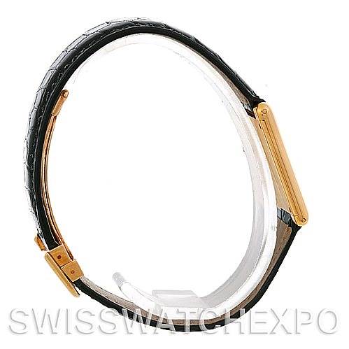 The image shows a side view of the Cartier Tank Classic Men's Yellow Gold White Dial Men's Yellow Gold White Dial watch, highlighting its black strap and gold case.