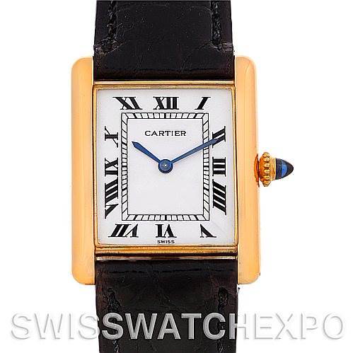 This image shows a frontal view of a Cartier Tank Classic watch with a rectangular gold case, Roman numerals, and black strap.