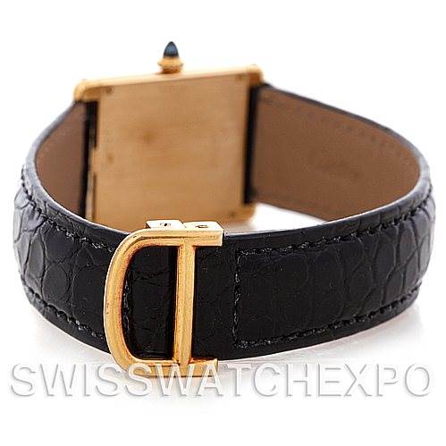 The image shows the back view of a Cartier Tank Classic Men's Yellow Gold White Dial Men's Yellow Gold White Dial watch, highlighting the leather strap and gold buckle.