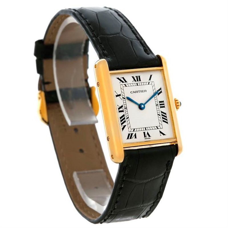 The image shows a Cartier Tank Classic watch from a front-angle, displaying its rectangular face, gold case, and black leather strap.