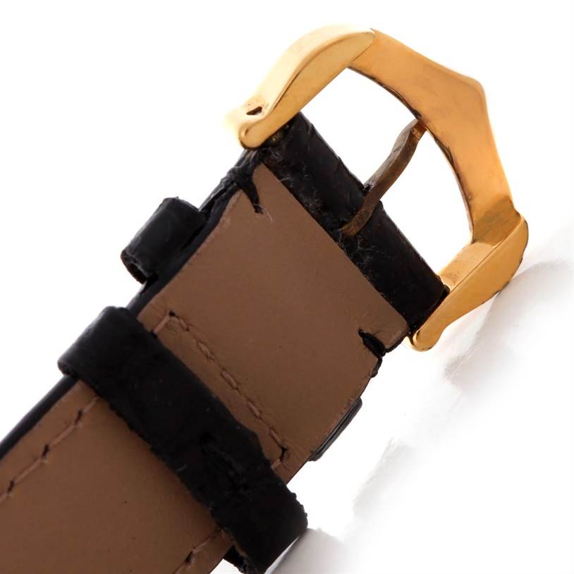 This is a close-up of the buckle and strap of a Cartier Tank Classic Men's Yellow Gold White Dial Men's Yellow Gold White Dial watch.