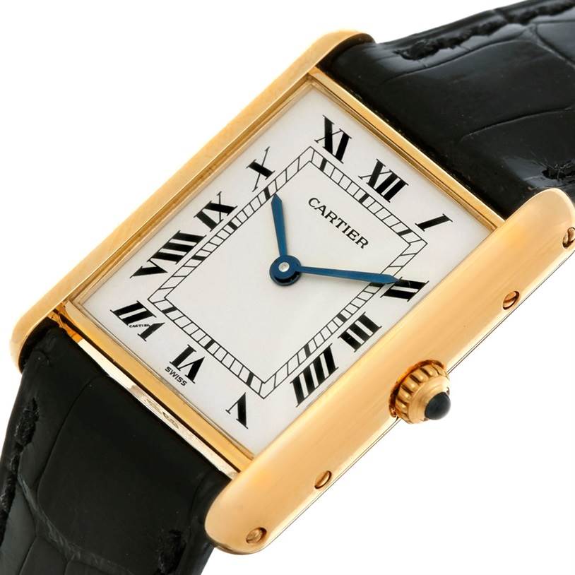 The image shows a Cartier Tank Classic Men's Yellow Gold White Dial Men's Yellow Gold White Dial watch at an oblique angle, highlighting its rectangular face, gold casing, and black leather strap.