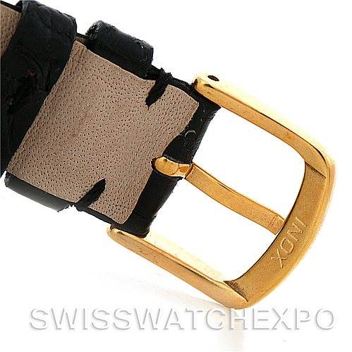 This image shows a close-up of the gold buckle and leather strap of the Cartier Tank Classic Men's Yellow Gold White Dial Men's Yellow Gold White Dial watch.