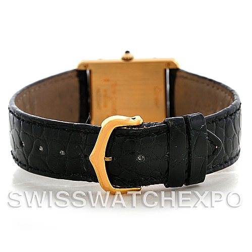 The image shows the back view of a Cartier Tank Classic Men's Yellow Gold White Dial Men's Yellow Gold White Dial watch, highlighting the black leather strap and gold buckle.