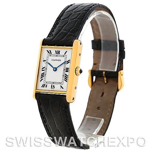 The image shows a Cartier Tank Classic Men's Yellow Gold White Dial Men's Yellow Gold White Dial watch at a three-quarter angle, displaying its face, crown, and black leather strap.