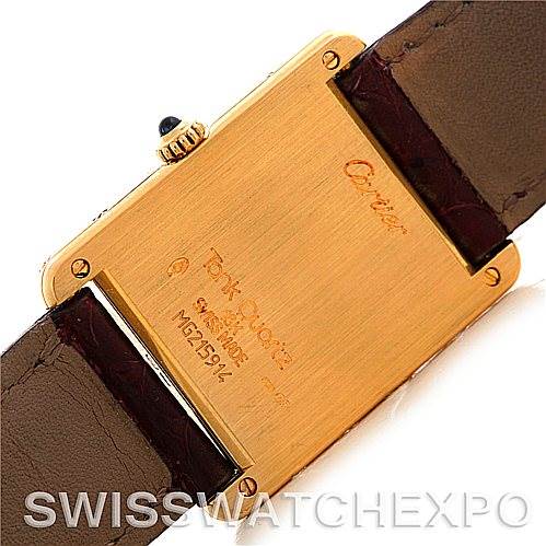 The image shows the back of a Cartier Tank Classic MG215914 Men's Yellow Gold White Dial MG215914 Men's Yellow Gold White Dial watch, highlighting the engraved details and leather strap attachments.