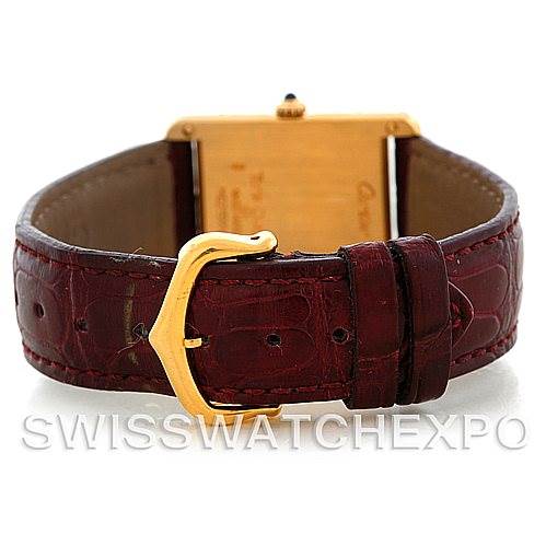 The image shows the back view of a Cartier Tank Classic MG215914 Men's Yellow Gold White Dial MG215914 Men's Yellow Gold White Dial watch with a brown leather strap and a gold buckle.