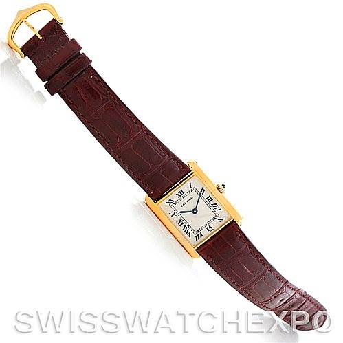 The image shows a top-down view of the Cartier Tank Classic MG215914 Men's Yellow Gold White Dial MG215914 Men's Yellow Gold White Dial watch, including its rectangular face and brown leather strap.