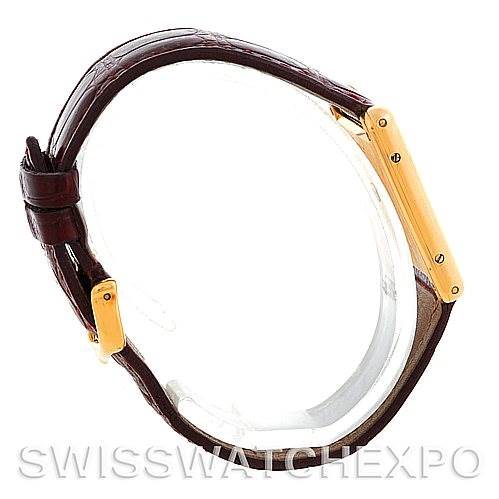 The image shows a side profile of the Cartier Tank Classic MG215914 Men's Yellow Gold White Dial MG215914 Men's Yellow Gold White Dial watch, highlighting the gold casing and brown leather strap.