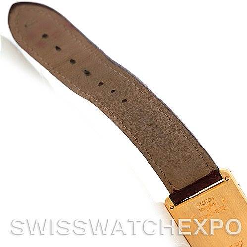 The image shows the back of the leather strap and case of a Cartier Tank Classic MG215914 Men's Yellow Gold White Dial MG215914 Men's Yellow Gold White Dial watch at an angle displaying the strap holes and case markings.