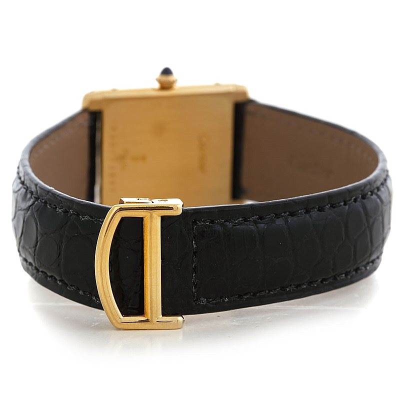 The image shows the reverse side of a Cartier Tank Classic Men's Yellow Gold White Dial Men's Yellow Gold White Dial watch, highlighting its buckle and the back of the watch case.