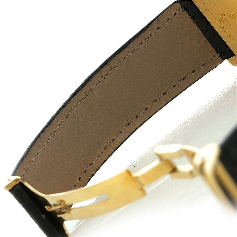 The image shows the inside view of the leather strap and the clasp mechanism of a Cartier Tank Classic Men's Yellow Gold White Dial Men's Yellow Gold White Dial watch.