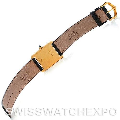 The image shows the back view of a Cartier Tank Classic Men
s Yellow Gold Silver Dial Men
s Yellow Gold Silver Dial watch, displaying its leather strap and case back.