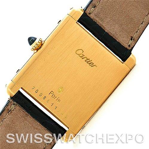 This image shows the back of a Cartier Tank Classic Men
s Yellow Gold Silver Dial Men
s Yellow Gold Silver Dial watch, highlighting the caseback and leather strap.