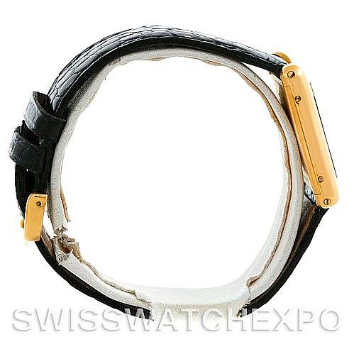 This image shows a side view of a Cartier Tank Classic Men
s Yellow Gold Silver Dial Men
s Yellow Gold Silver Dial watch, highlighting the black leather strap and gold case.