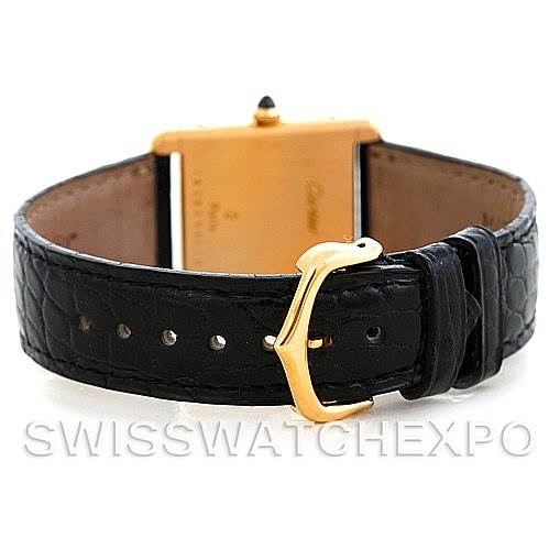 The image shows the back and black leather strap of a Cartier Tank Classic Men
s Yellow Gold Silver Dial Men
s Yellow Gold Silver Dial watch, including its golden buckle.