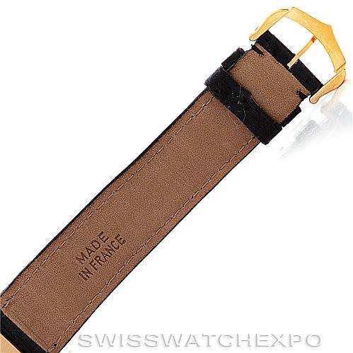 The image shows the underside of the leather strap and gold buckle of a Cartier Tank Classic Men's Yellow Gold White Dial Men's Yellow Gold White Dial watch.