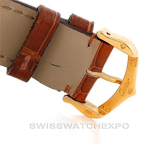 The image shows a close-up of the Cartier Tank Classic Men's Yellow Gold Silver Dial Men's Yellow Gold Silver Dial watch’s leather strap and gold buckle.