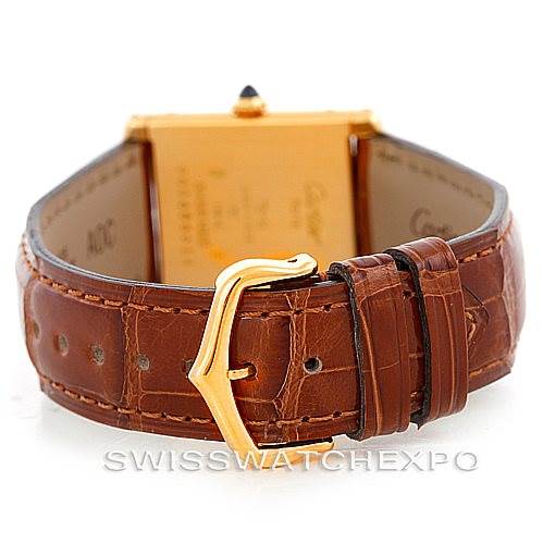 The image shows the back view of a Cartier Tank Classic Men's Yellow Gold Silver Dial Men's Yellow Gold Silver Dial watch, highlighting the brown leather strap and gold-tone buckle.