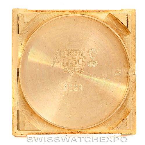 This image shows the interior case back of a Cartier Tank Classic Men's Yellow Gold Silver Dial Men's Yellow Gold Silver Dial watch, emphasizing its markings and material.