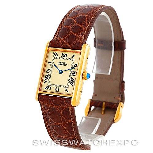 This image shows a side view of a Cartier Tank Classic W002953 Men's Yellow Gold Champagne Dial W002953 Men's Yellow Gold Champagne Dial watch, highlighting the face, leather strap, and crown with a blue cabochon.