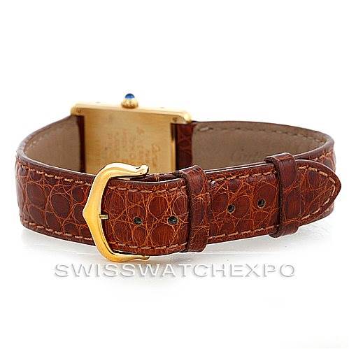 The image shows the back view of a Cartier Tank Classic W002953 Men's Yellow Gold Champagne Dial W002953 Men's Yellow Gold Champagne Dial watch, highlighting its brown leather strap and gold buckle.