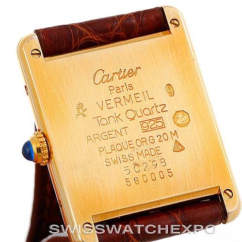 The image shows the back of the Cartier Tank Classic W002953 Men's Yellow Gold Champagne Dial W002953 Men's Yellow Gold Champagne Dial watch, highlighting its inscriptions and the leather strap.