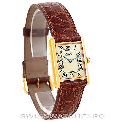 The image shows a Cartier Tank Classic W002953 Men's Yellow Gold Champagne Dial W002953 Men's Yellow Gold Champagne Dial watch from a front angle, highlighting its rectangular face, Roman numeral dial, and brown leather strap.