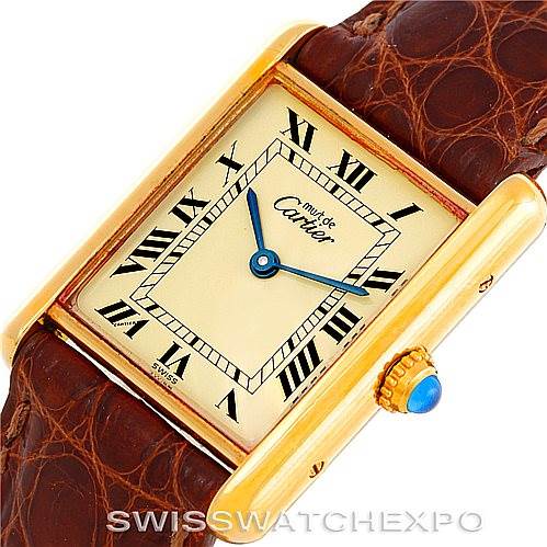 This image shows a close-up of the Cartier Tank Classic W002953 Men's Yellow Gold Champagne Dial W002953 Men's Yellow Gold Champagne Dial watch at an oblique angle, highlighting the dial, roman numerals, hands, bezel, and crown.