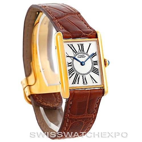 The image shows a Cartier Tank Classic W002953 Men's Yellow Gold White Dial W002953 Men's Yellow Gold White Dial watch at a slight front-side angle, showcasing the face, brown leather strap, and gold casing.
