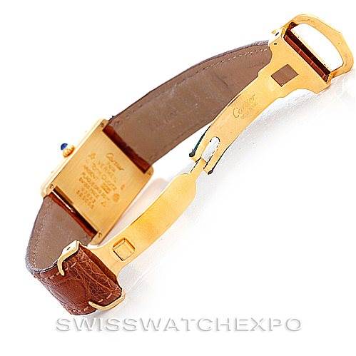 The image shows a Cartier Tank Classic W002953 Men's Yellow Gold White Dial W002953 Men's Yellow Gold White Dial watch from the back, highlighting the buckle, clasp, and parts of the leather strap.