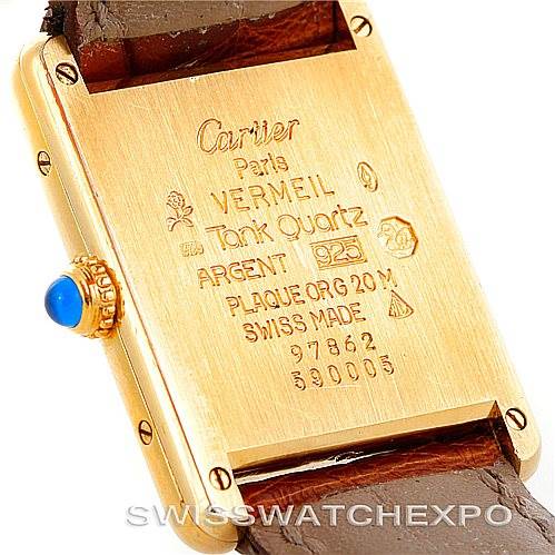 This image shows the back casing of the Cartier Tank Classic W002953 Men's Yellow Gold White Dial W002953 Men's Yellow Gold White Dial watch, highlighting its markings and the leather strap attachment.
