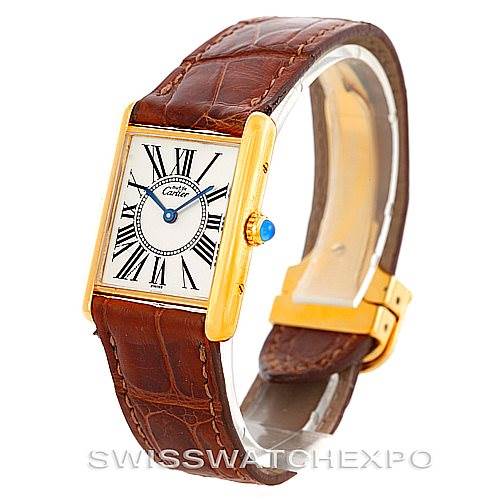 The image shows a Cartier Tank Classic W002953 Men's Yellow Gold White Dial W002953 Men's Yellow Gold White Dial model watch at a front angle, highlighting the rectangular face, Roman numeral dial, and brown leather strap.