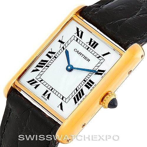 The image shows a Cartier Tank Classic 7808613746 Men's Yellow Gold White Dial 7808613746 Men's Yellow Gold White Dial watch at an oblique angle, highlighting its rectangular face, Roman numerals, and black leather strap.