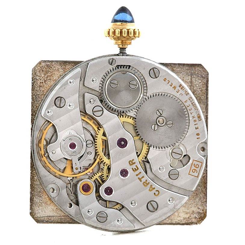 The image shows the mechanical movement parts of a Cartier Tank Classic Men
s Yellow Gold White Dial Men
s Yellow Gold White Dial watch, viewed from the back.