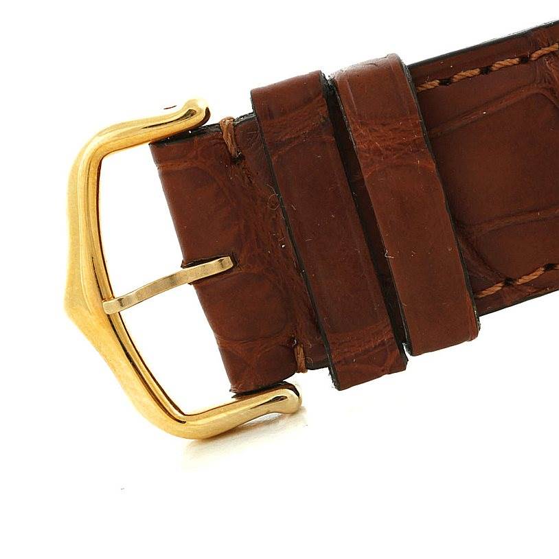 This image shows a close-up of the brown leather strap and gold buckle of the Cartier Tank Classic Men
s Yellow Gold White Dial Men
s Yellow Gold White Dial watch.