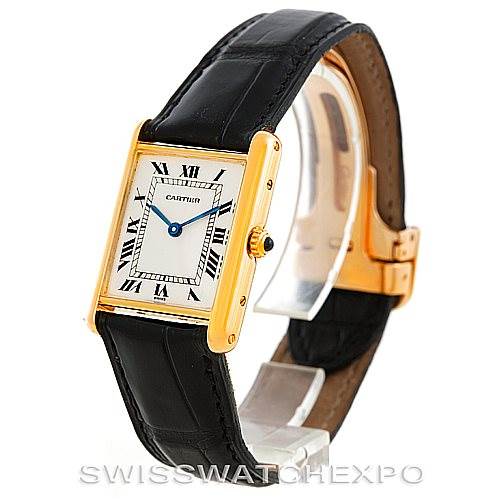 The Cartier Tank Classic Men's Yellow Gold Silver Dial Men's Yellow Gold Silver Dial watch is shown at a slight angle, highlighting its face, strap, and clasp.