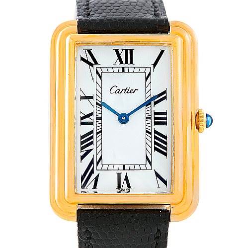 The image shows a front view of the Cartier Tank Classic Men's Yellow Gold White Dial Men's Yellow Gold White Dial watch, highlighting its Roman numerals, blue hands, and leather strap.