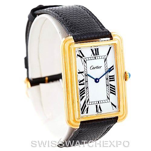 This image shows a Cartier Tank Classic Men's Yellow Gold White Dial Men's Yellow Gold White Dial watch at a three-quarter angle, highlighting its rectangular face, Roman numerals, and leather strap.