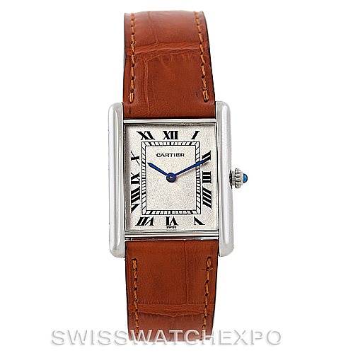 The image shows a front view of a Cartier Tank Classic Men
s Platinum Silver Dial Men
s Platinum Silver Dial watch with a brown leather strap and a rectangular face displaying Roman numerals.