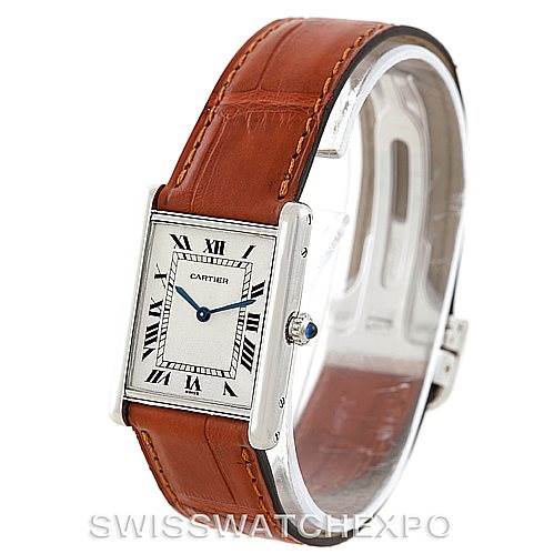 This Cartier Tank Classic Men
s Platinum Silver Dial Men
s Platinum Silver Dial watch is shown at a three-quarter front angle, displaying its rectangular face, brown leather strap, and silver bezel.