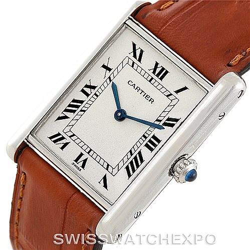 The image shows a close-up angle of a Cartier Tank Classic Men
s Platinum Silver Dial Men
s Platinum Silver Dial watch displaying its rectangular dial, Roman numerals, and brown leather strap.