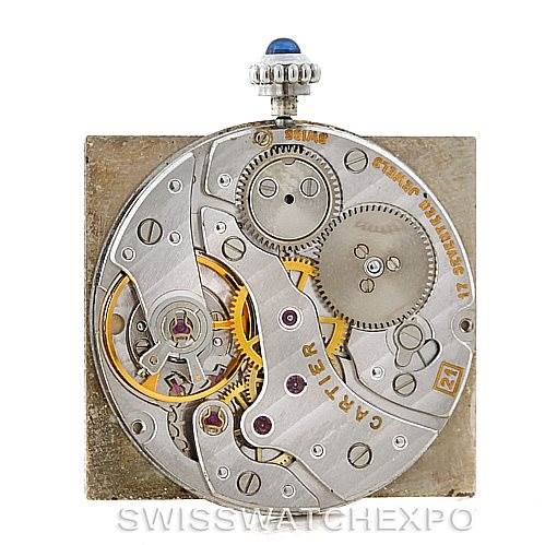 This image shows the internal mechanism of a Cartier Tank Classic Men
s Platinum Silver Dial Men
s Platinum Silver Dial watch from a top-down perspective, highlighting gears and components.