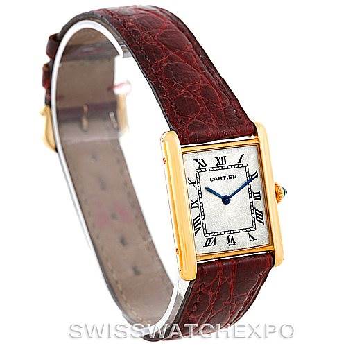 The image shows a Cartier Tank Classic 960655124 Men's Yellow Gold Silver Dial 960655124 Men's Yellow Gold Silver Dial watch at a slight angle, highlighting its rectangular face, gold casing, and brown leather strap.