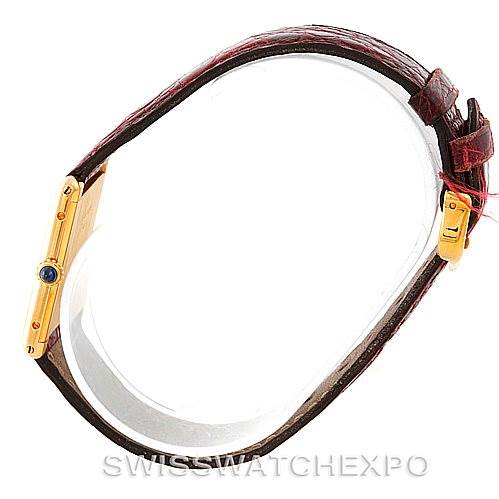 The image shows a side view of a Cartier Tank Classic 960655124 Men's Yellow Gold Silver Dial 960655124 Men's Yellow Gold Silver Dial watch, highlighting the watch's side profile and brown leather strap.