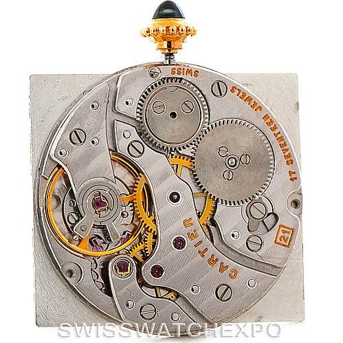 This image shows the inner mechanical movement of a Cartier Tank Classic 960655124 Men's Yellow Gold Silver Dial 960655124 Men's Yellow Gold Silver Dial watch, highlighting its gears and intricate components.