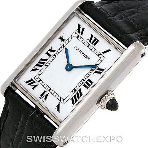 The image shows a Cartier Tank Classic Men's White Gold White Dial Men's White Gold White Dial watch at a slight angle, highlighting the face, Roman numerals, blue hands, and a black leather strap.