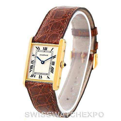 The image shows a Cartier Tank Classic Men's Yellow Gold Silver Dial Men's Yellow Gold Silver Dial watch at a slight angle, featuring its rectangular face, Roman numeral dial, and brown leather strap.