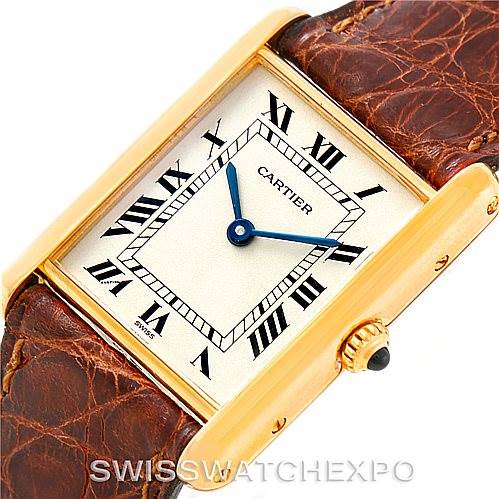 The image shows a Cartier Tank Classic Men's Yellow Gold Silver Dial Men's Yellow Gold Silver Dial watch from a top-down angle, highlighting its gold case, brown leather strap, and Roman numeral dial.