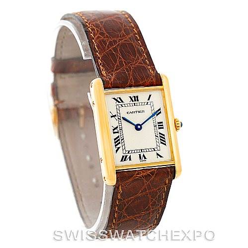 The image shows a Cartier Tank Classic Men's Yellow Gold Silver Dial Men's Yellow Gold Silver Dial model watch at a slight angle, featuring its rectangular face, Roman numerals, and brown leather strap.